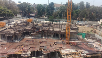 Brigade Nanda Heights Tower A (view from North side) : Ground floor works completed. Podium slab works are in progress as on February '23